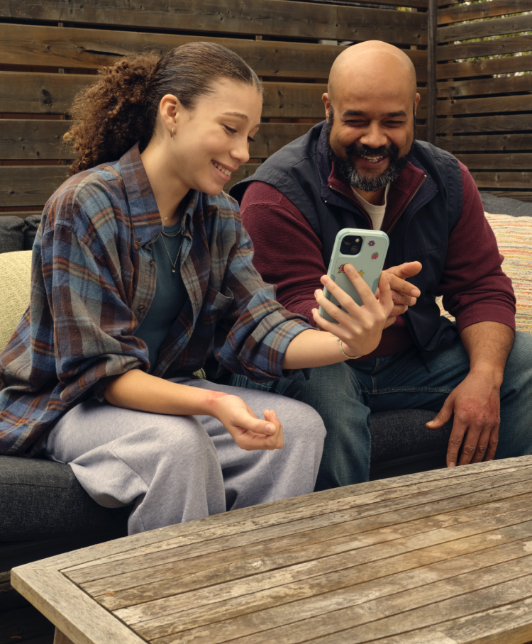 Teenager and dad looking at a phone