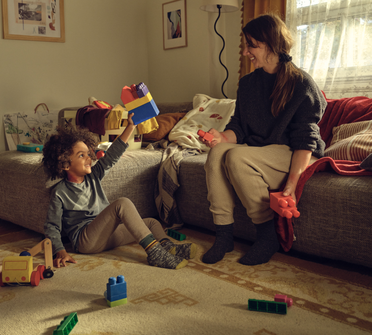 A little boy and woman playing with blocks