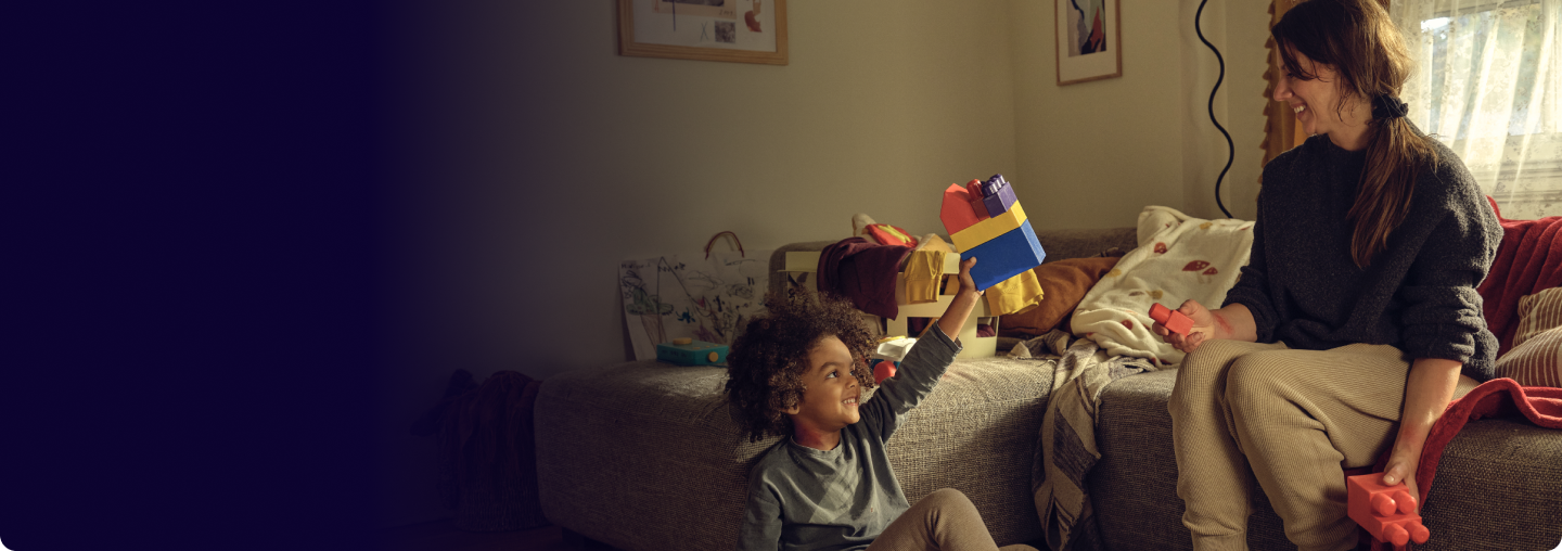 A little boy and woman playing with blocks